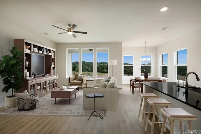a living room with fireplace furniture and a large window