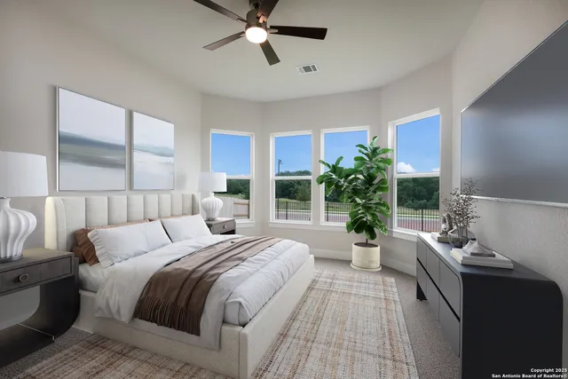 a bedroom with a large bed and a chandelier