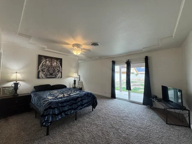 a spacious bedroom with a bed and a couch