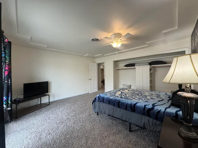 a bedroom with bed and a chandelier