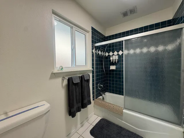 a bathroom with a shower and a toilet