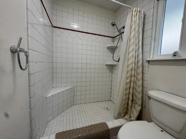 a bathroom with a toilet and shower