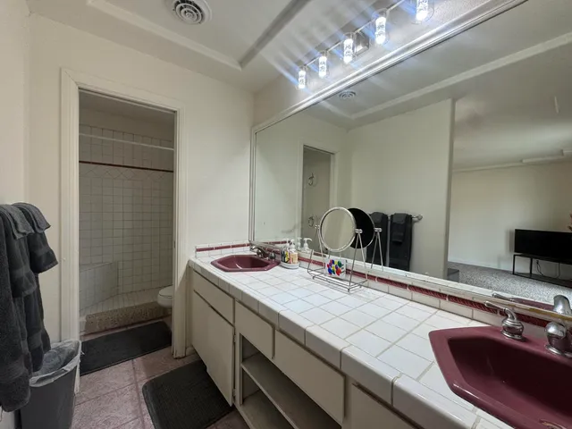 a bathroom with a sink double vanity and a mirror