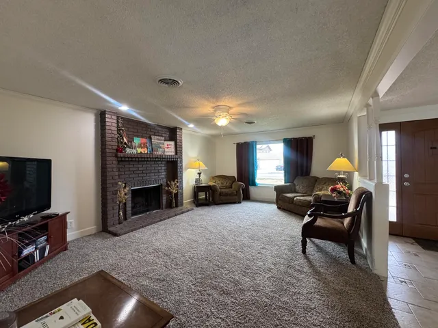 a living room with furniture and a fireplace