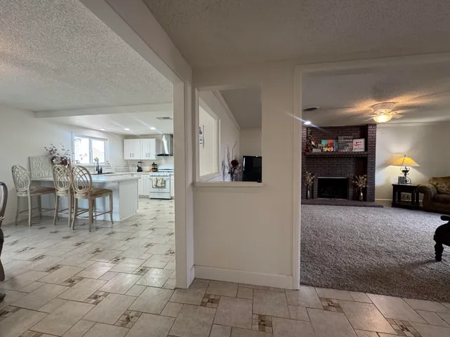 a view of a livingroom with furniture and a fireplace
