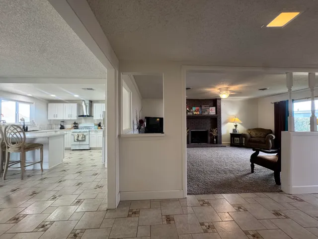 a view of a living room kitchen and a window