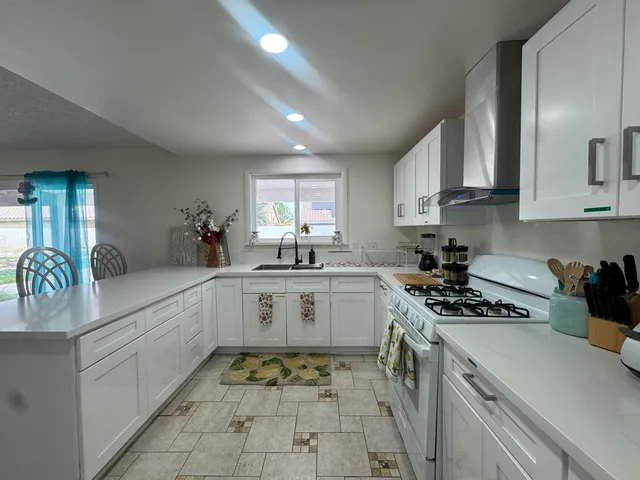 a kitchen with a sink stove and cabinets