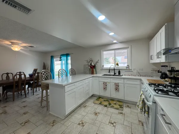 a kitchen that has a lot of cabinets in it and appliances