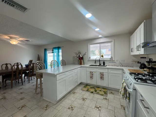 a kitchen that has a lot of cabinets in it and appliances