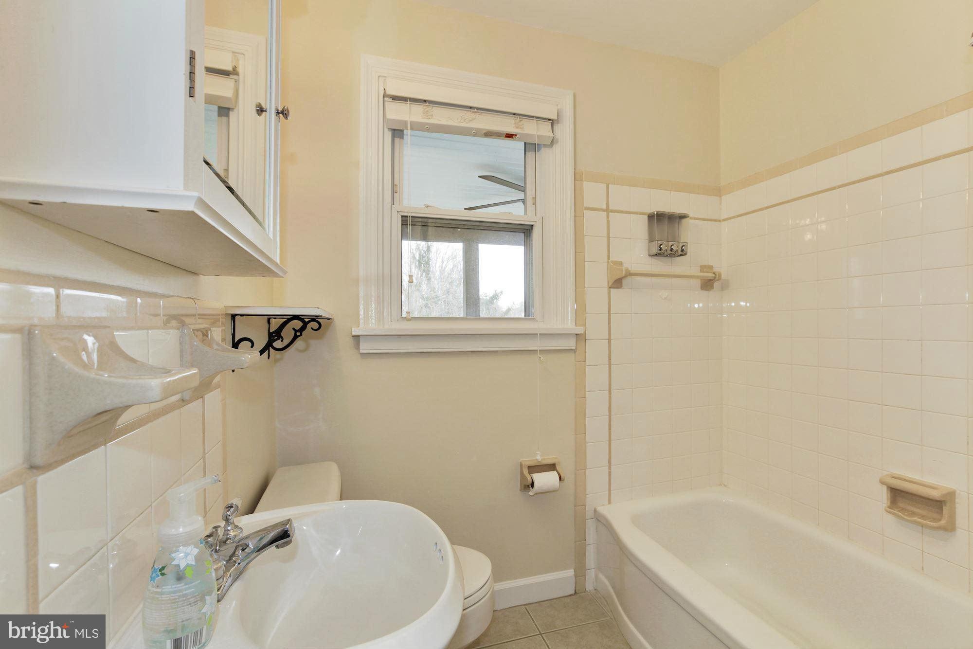 2515 Mason Street Silver Spring, MD 20902 - Photo 7 of 30 a bathroom with a tub sink and mirror
