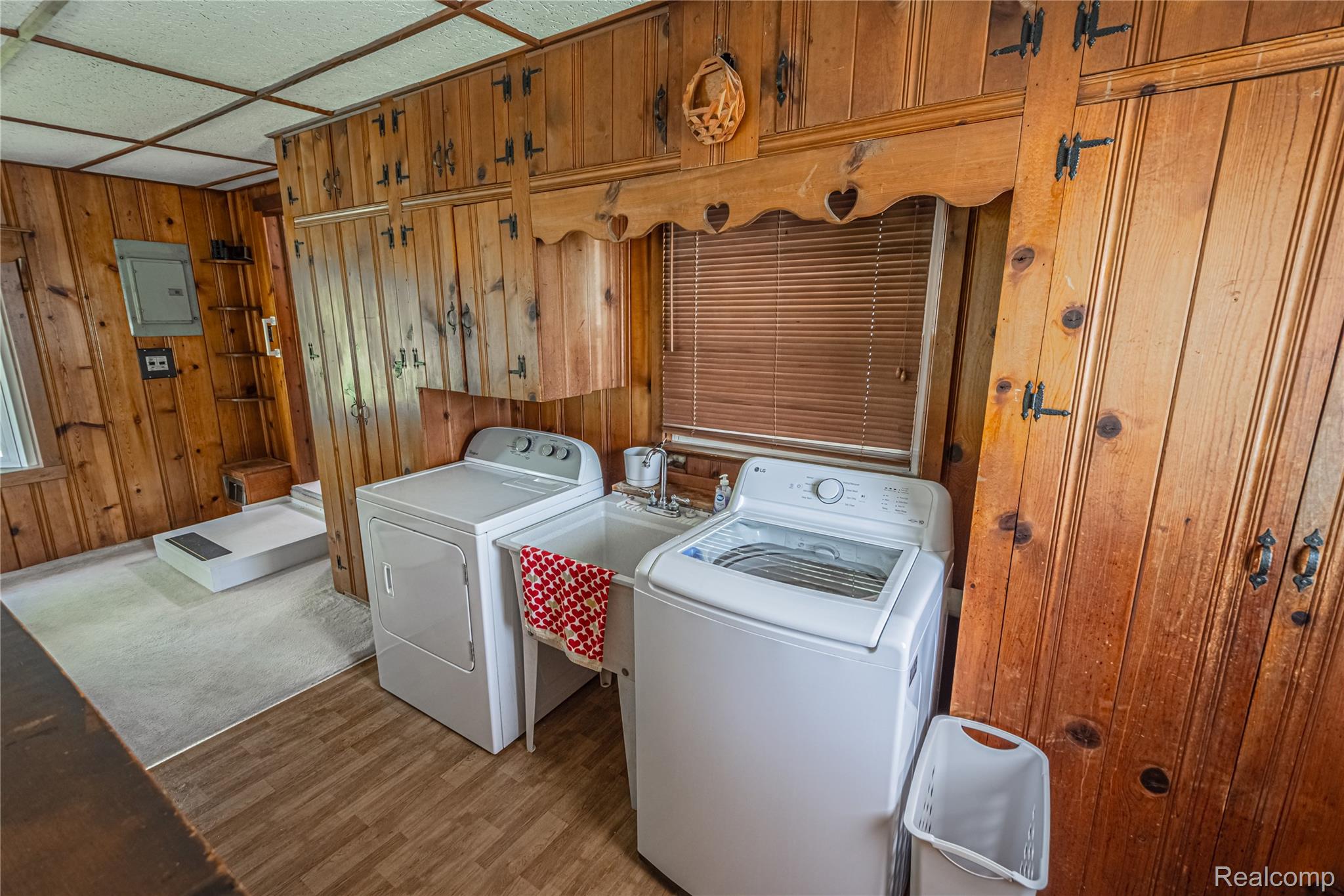 8384 Imlay City Road Avoca, MI 48006 - Photo 23 of 39 Utility area featuring wood-finish wall paneling and a large utility sink