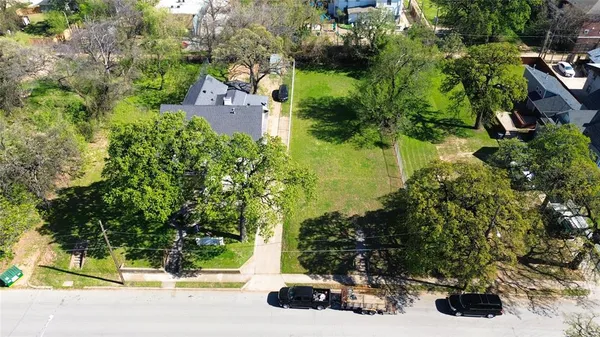 an aerial view of a house with a yard and garden