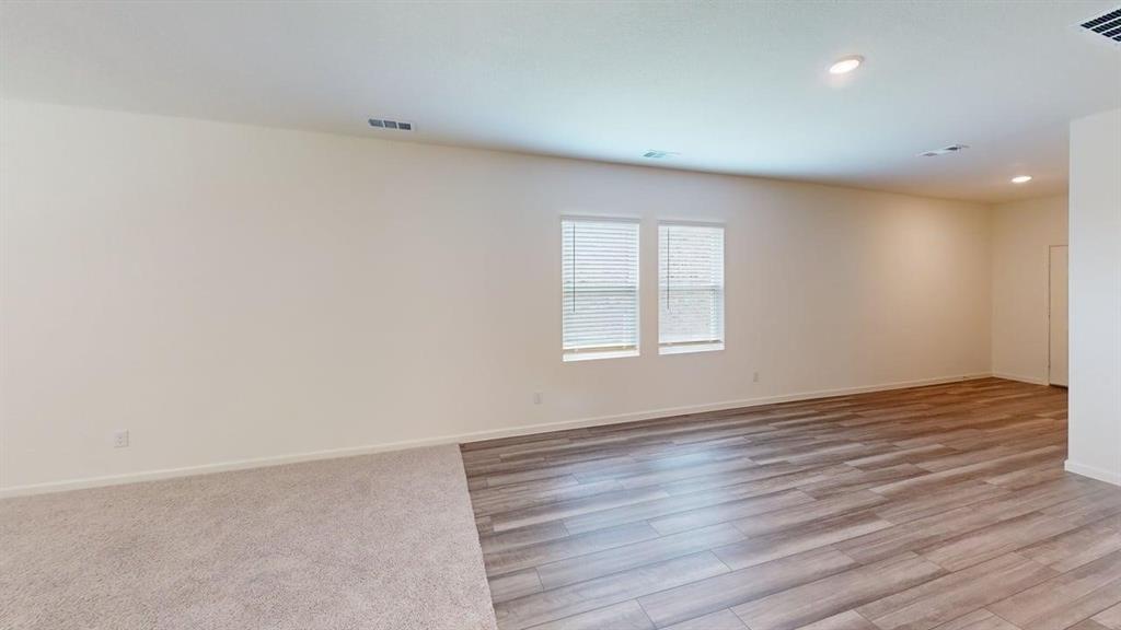 4529 Winecup Road Melissa, TX 75454 - Photo 5 of 29 Spacious interior featuring two-tone flooring with plush carpeting and wood-finish flooring
