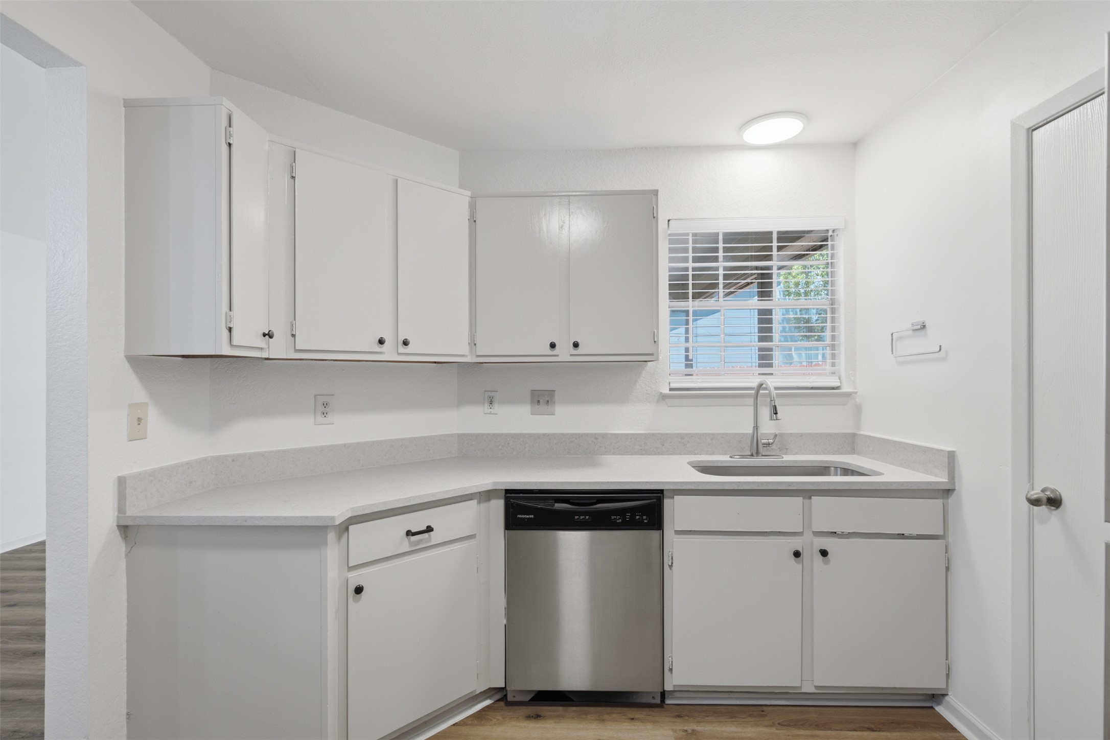 11611 Rustic Rock Drive, Unit B Austin, TX 78750 - Photo 10 of 30 White cabinetry, stainless steel appliances, and a window above the sink define this well-appointed kitchen.