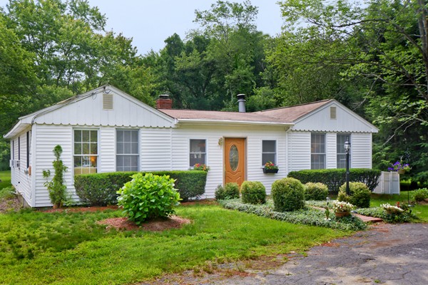 a front view of a house with a yard
