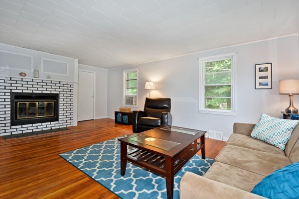253 West Acton Road Stow, MA 01775 - Photo 2 of 21 a living room with furniture and a fireplace
