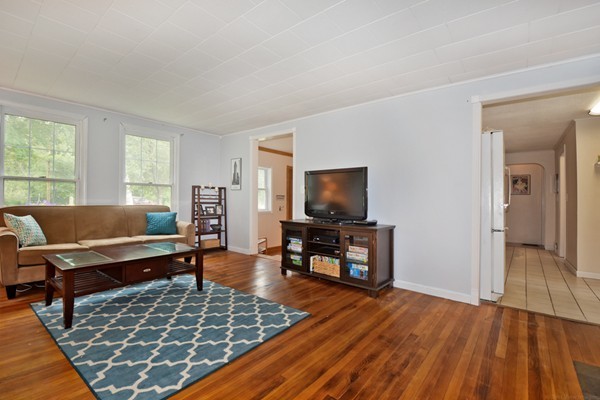 253 West Acton Road Stow, MA 01775 - Photo 3 of 21 a living room with furniture and a flat screen tv