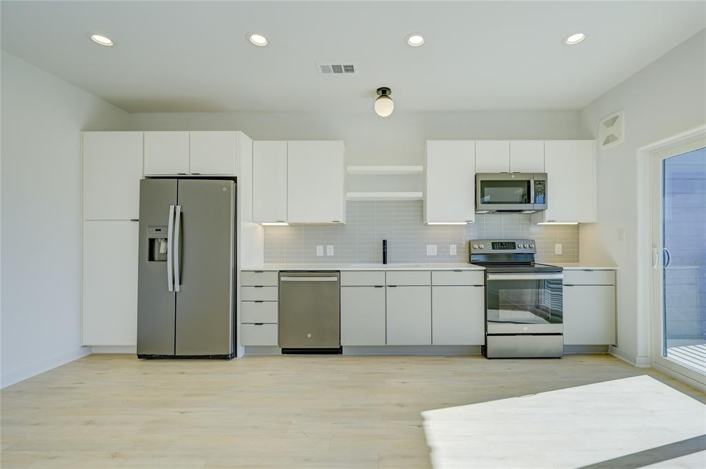 100 West Mockingbird Lane, Unit 403 Austin, TX 78745 - Photo 11 of 13 a kitchen with a refrigerator stove and microwave