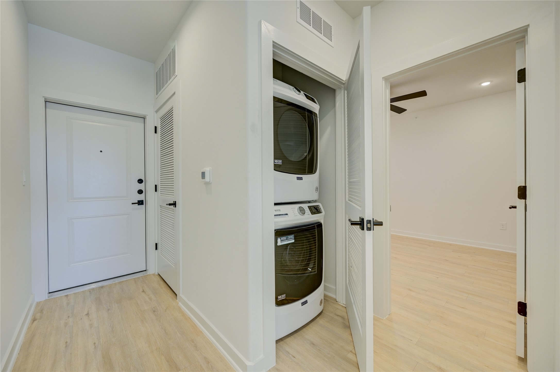 100 West Mockingbird Lane, Unit 403 Austin, TX 78745 - Photo 9 of 13 a view of a hallway with wooden floor and closet area