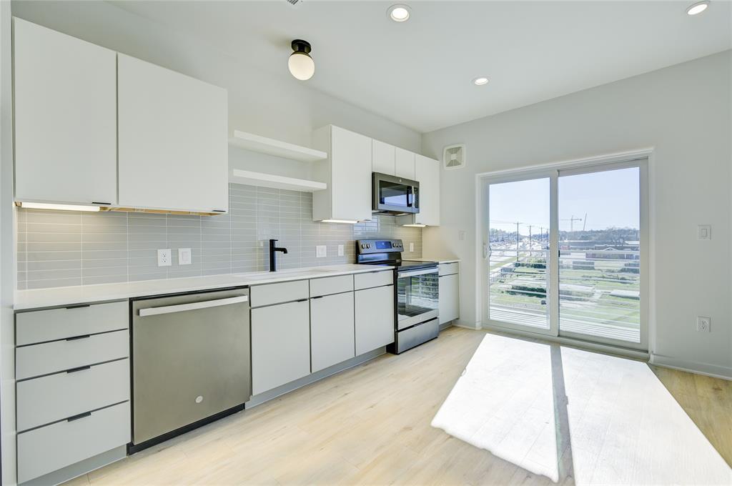 100 West Mockingbird Lane, Unit 403 Austin, TX 78745 - Photo 10 of 13 a kitchen with a refrigerator and a sink