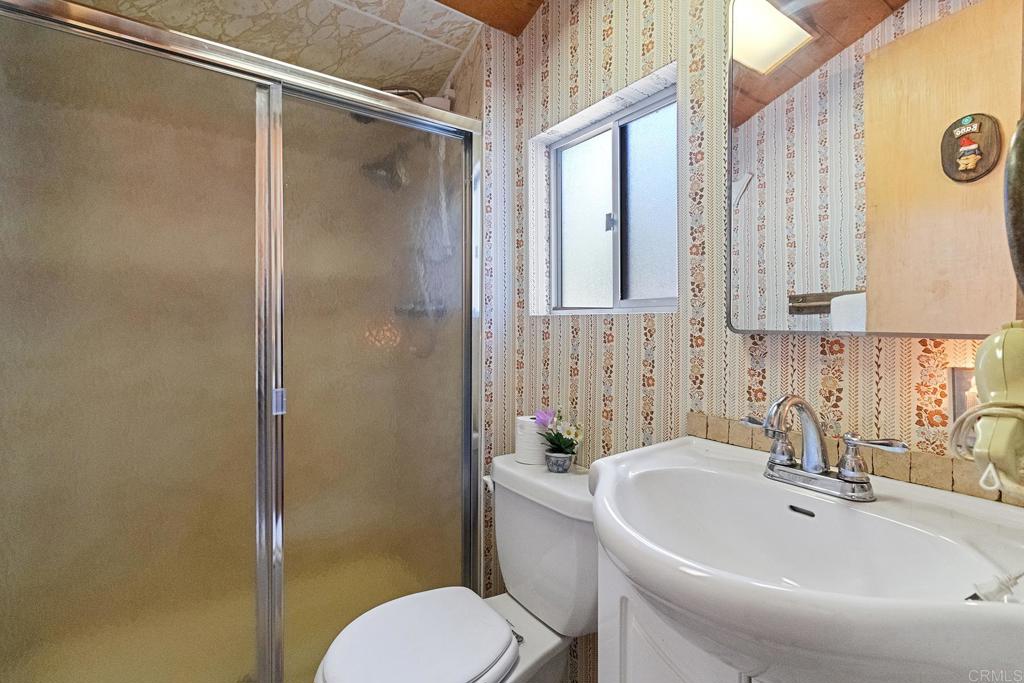 9150- Pine Creek Road, Unit 39 Pine Valley, CA 91962 - Photo 13 of 27 a bathroom with a sink a toilet and shower