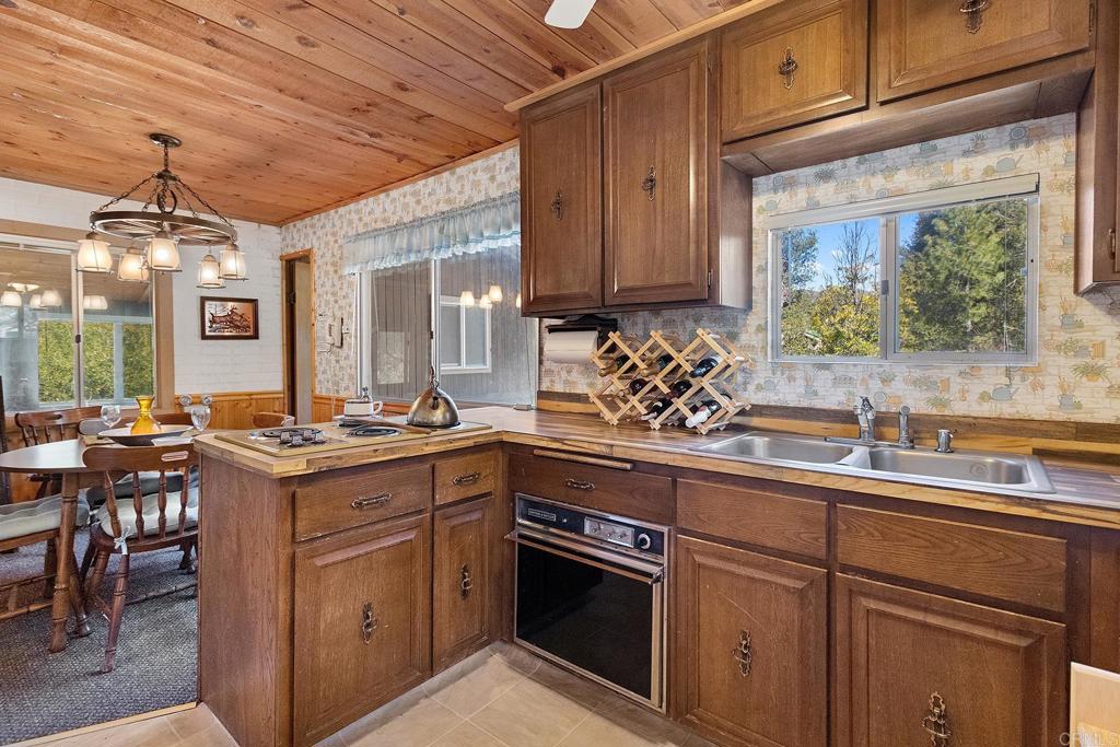 9150- Pine Creek Road, Unit 39 Pine Valley, CA 91962 - Photo 18 of 27 a kitchen with a sink stove and cabinets