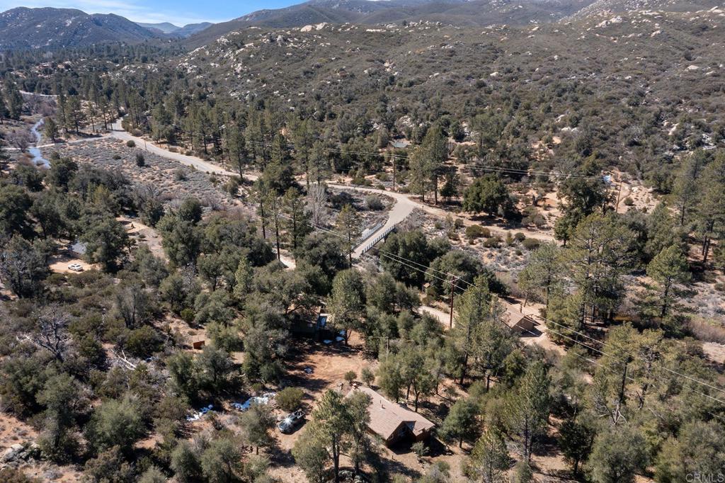9150- Pine Creek Road, Unit 39 Pine Valley, CA 91962 - Photo 25 of 27 an aerial view of house with yard and mountain view in back
