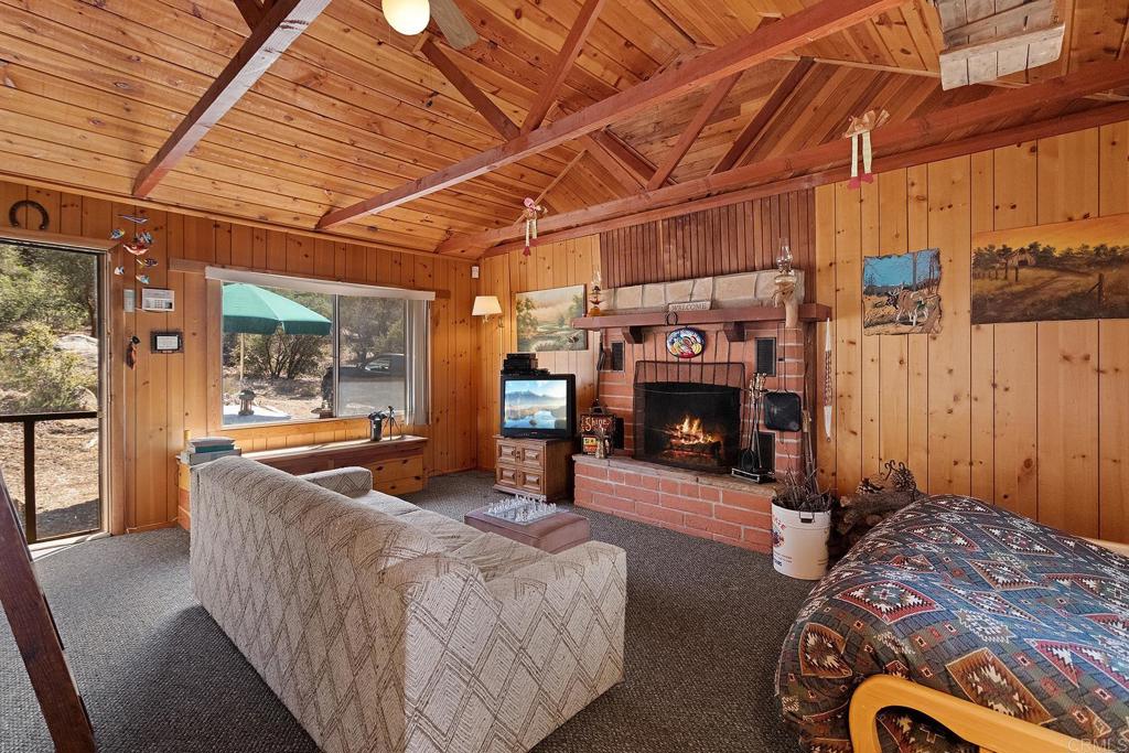 9150- Pine Creek Road, Unit 39 Pine Valley, CA 91962 - Photo 3 of 27 a bed room with furniture and a fireplace