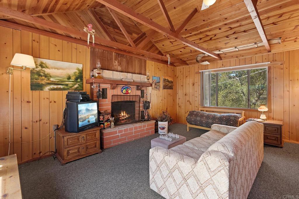 9150- Pine Creek Road, Unit 39 Pine Valley, CA 91962 - Photo 4 of 27 a living room with furniture a fireplace and a table