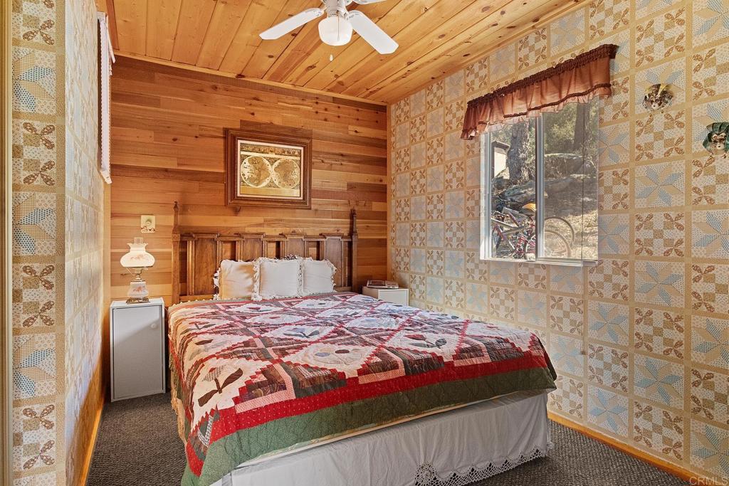 9150- Pine Creek Road, Unit 39 Pine Valley, CA 91962 - Photo 7 of 27 a bedroom with a bed and a wall painting