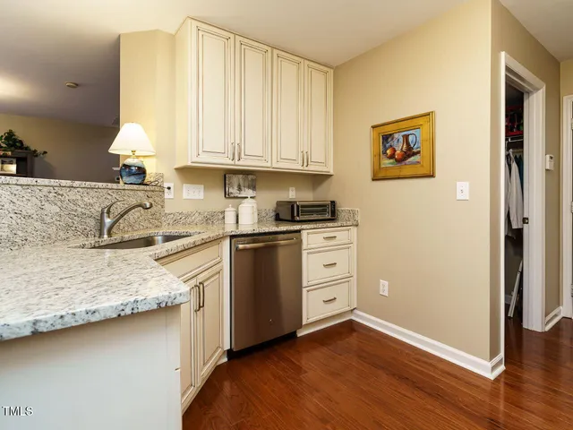 a kitchen with granite countertop white cabinets and white appliances