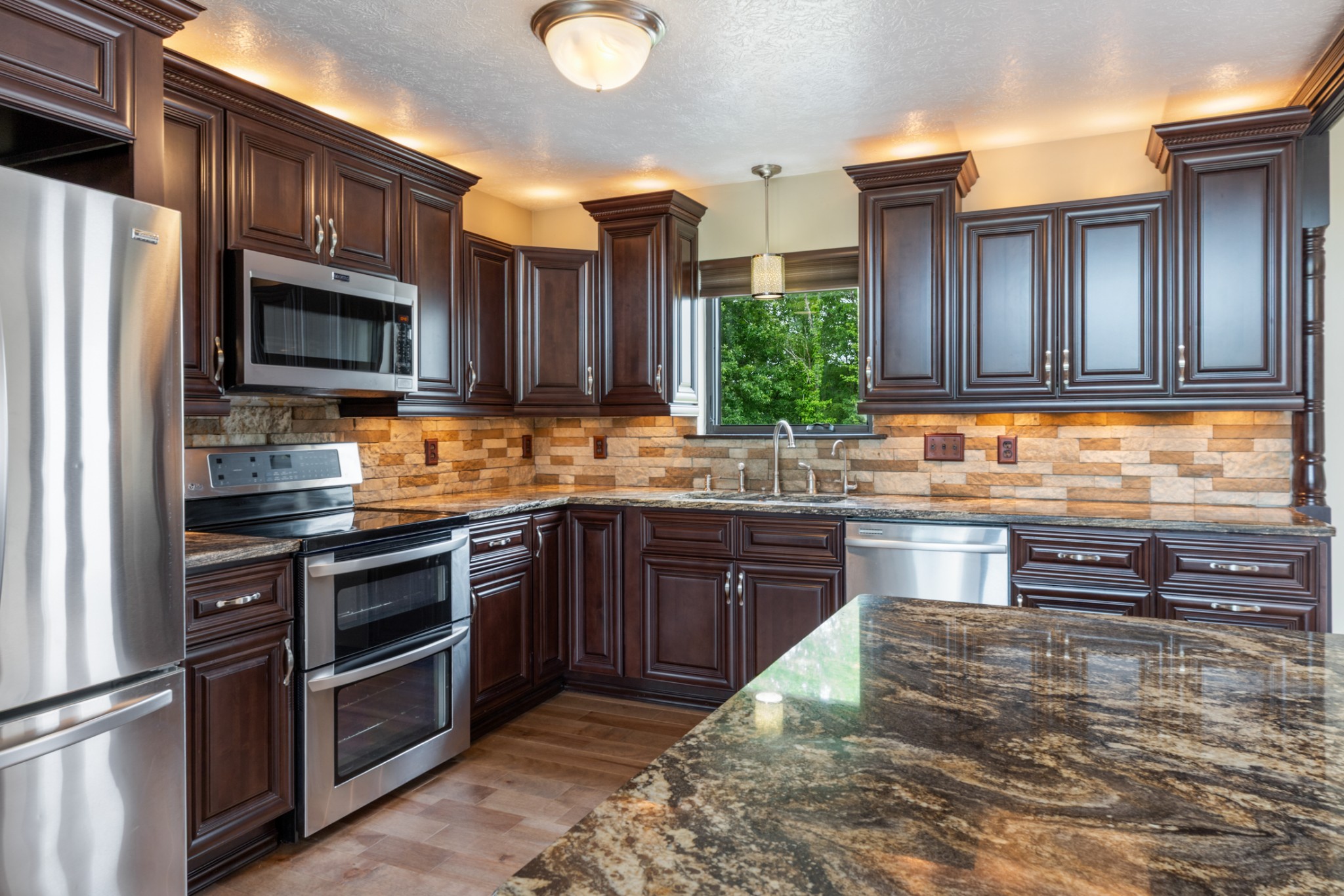 3791 Sylvia Road Dickson, TN 37055 - Photo 13 of 96 a kitchen with stainless steel appliances granite countertop a stove refrigerator and cabinets
