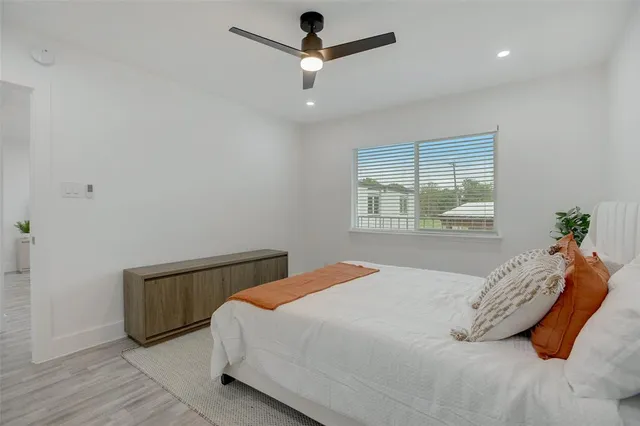 a bedroom with a bed a chandelier and closet