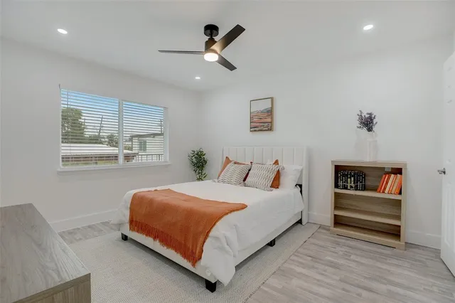 a bedroom with a bed and a potted plant