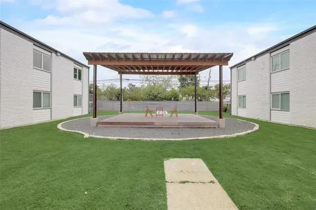 a backyard of a house with table and chairs