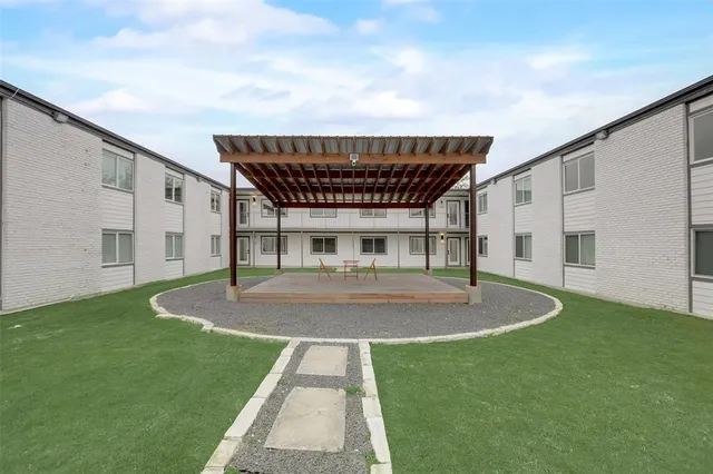 a backyard of a house with table and chairs