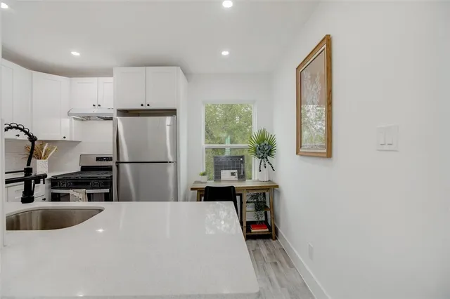 a kitchen with a sink a refrigerator and window