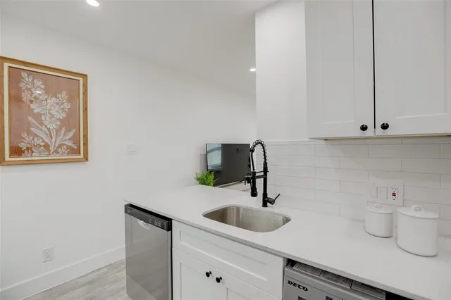 a kitchen with a sink and cabinets