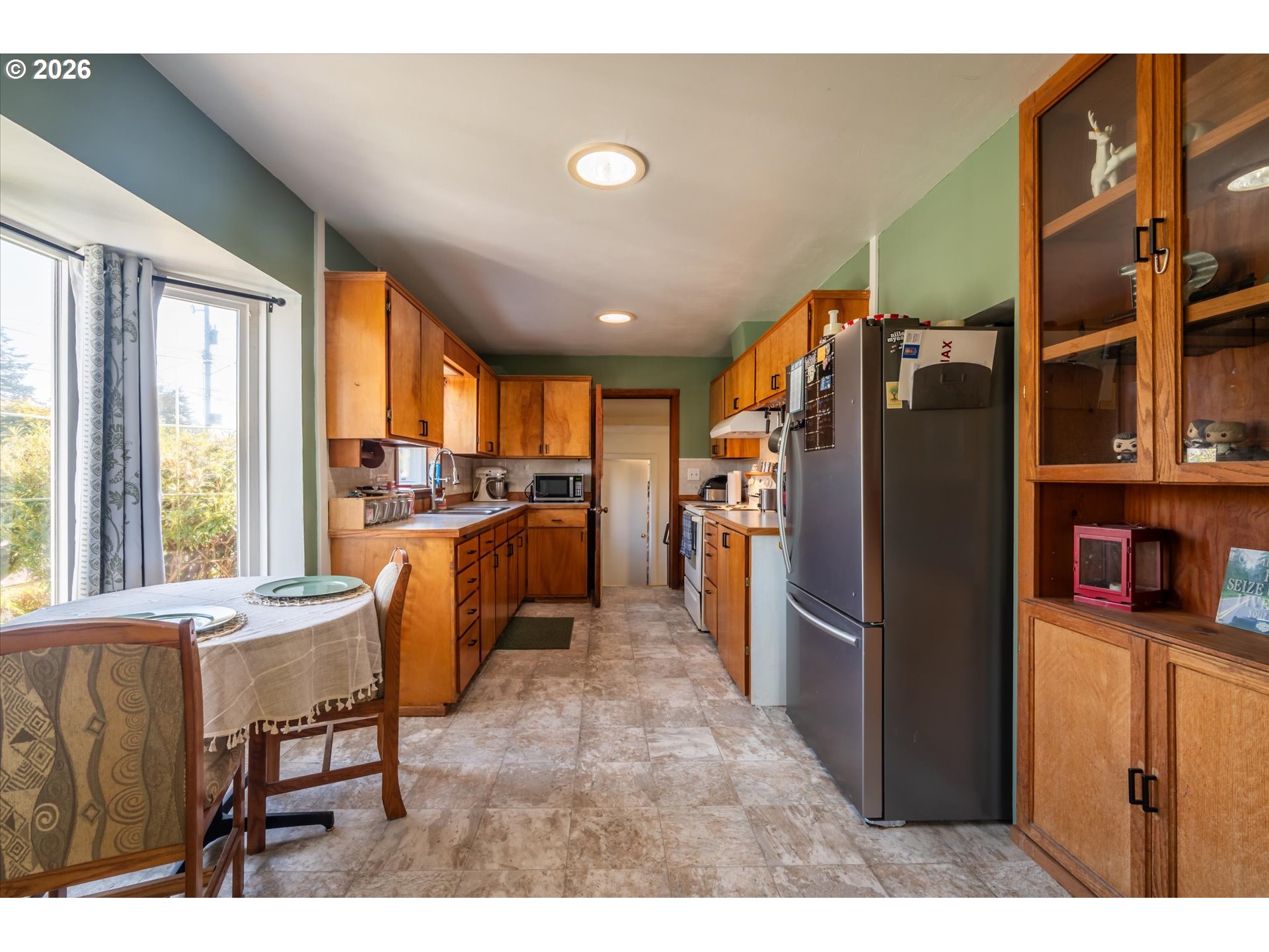 1789 14th Street North Bend, OR 97459 - Photo 13 of 43 a kitchen with stainless steel appliances granite countertop a refrigerator and a sink