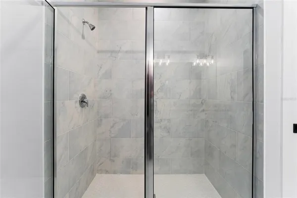 a bathroom with a glass shower door