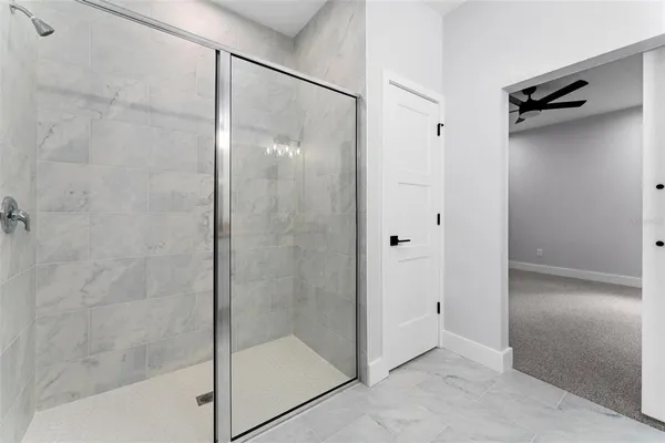 a bathroom with a glass shower door
