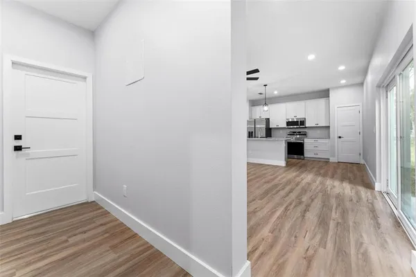 a view of a kitchen from the hallway