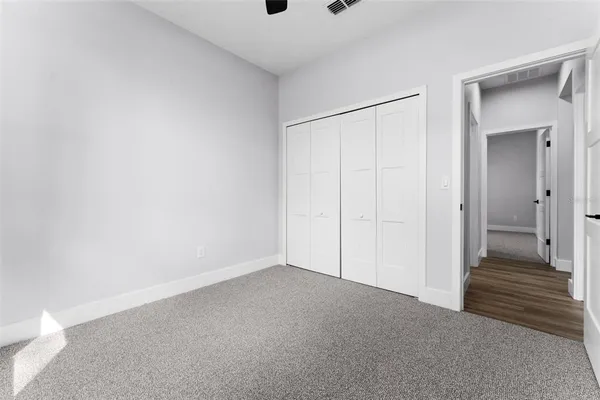 a view of a room with an empty space and wooden floor