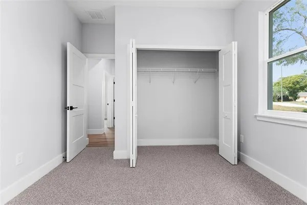 a view of room with window and a ceiling fan