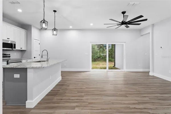 a view of a kitchen with a sink stainless steel appliances and cabinets