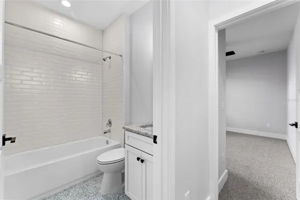 a bathroom with a toilet and a bathtub
