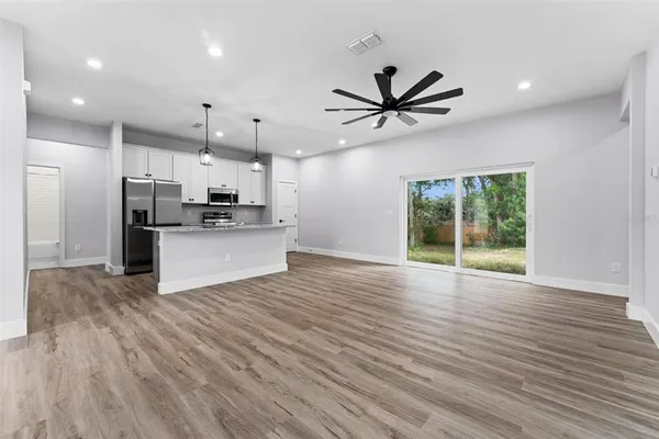 a view of a kitchen with a sink and a refrigerator