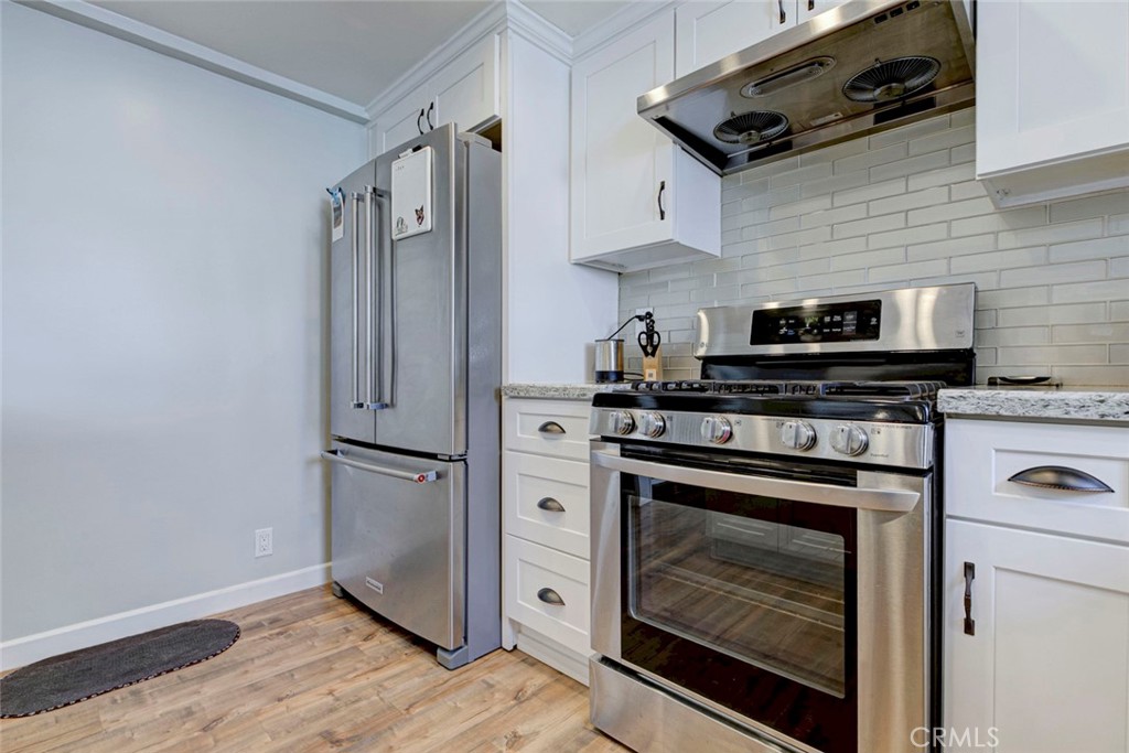 6911 Valmont Street Tujunga, CA 91042 - Photo 23 of 55 a kitchen with stainless steel appliances a stove microwave and refrigerator