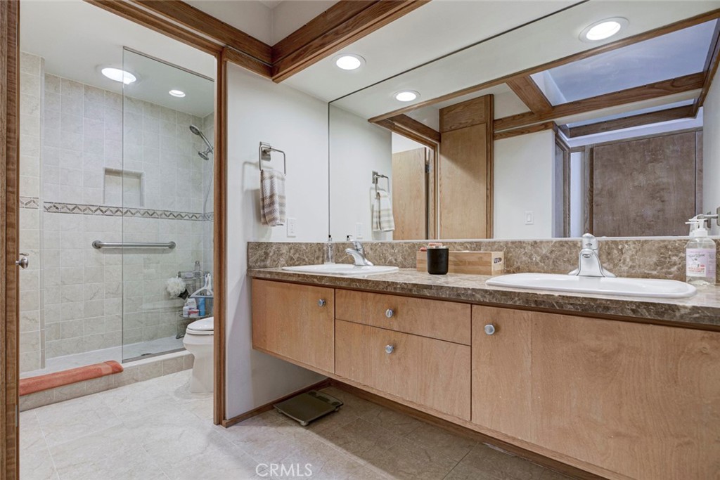 6911 Valmont Street Tujunga, CA 91042 - Photo 28 of 55 a spacious bathroom with a granite countertop sink mirror and shower