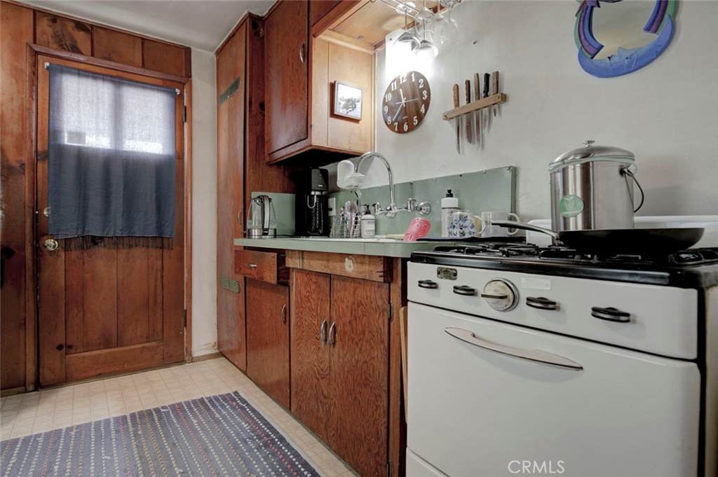 6911 Valmont Street Tujunga, CA 91042 - Photo 46 of 55 a kitchen with stainless steel appliances granite countertop a refrigerator and a stove